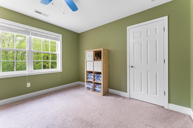 unfurnished bedroom with carpet, baseboards, and ceiling fan
