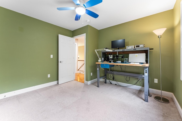 carpeted office featuring ceiling fan and baseboards