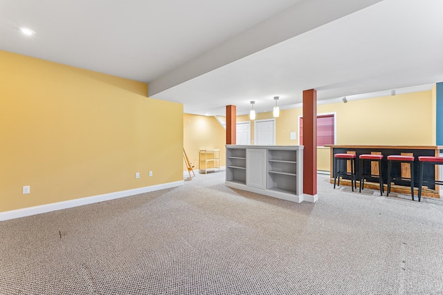 unfurnished living room with carpet flooring, baseboards, a bar, and recessed lighting