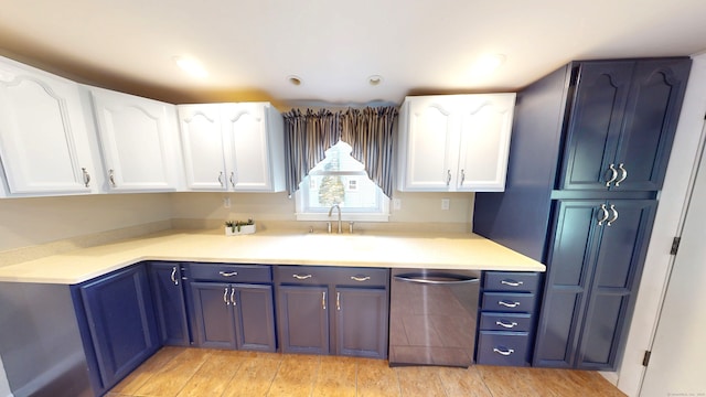 kitchen featuring dishwasher, blue cabinetry, and white cabinets