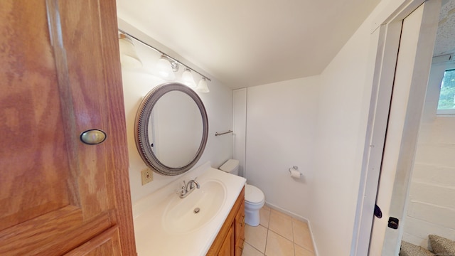 bathroom with tile patterned floors, vanity, toilet, and baseboards