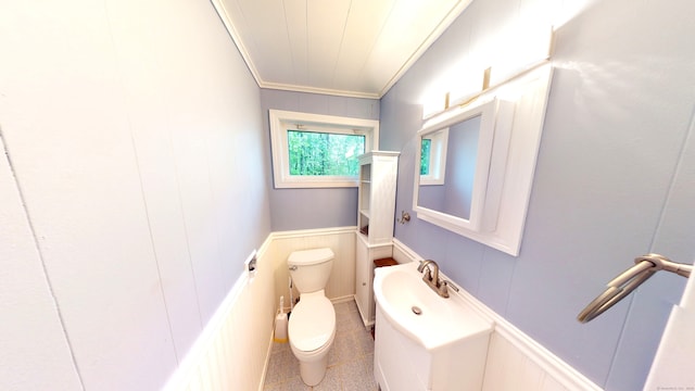 bathroom with crown molding and toilet
