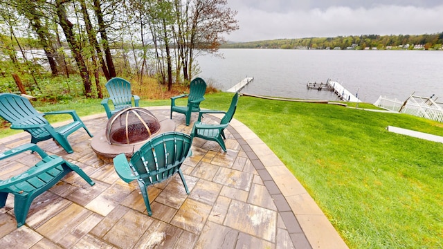 view of patio featuring a fire pit, a water view, and a dock