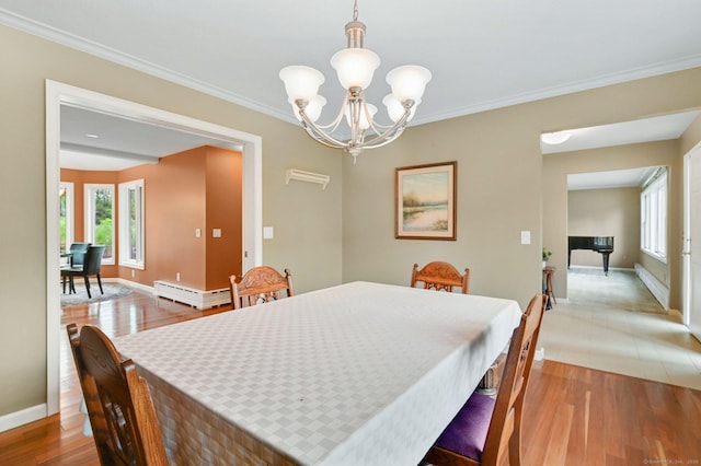 dining room with baseboards, a chandelier, wood finished floors, crown molding, and a baseboard heating unit