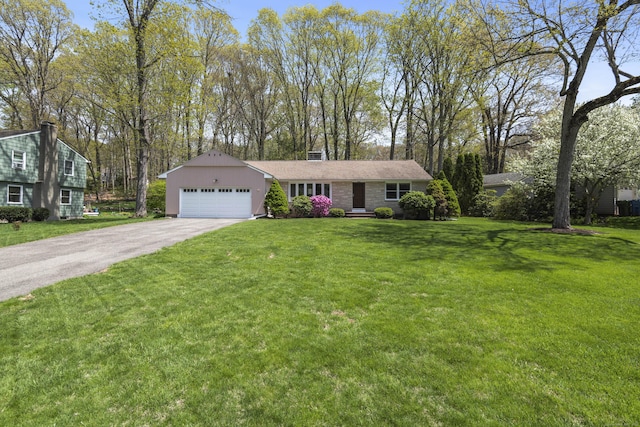 ranch-style house with a garage, asphalt driveway, a front lawn, and a chimney