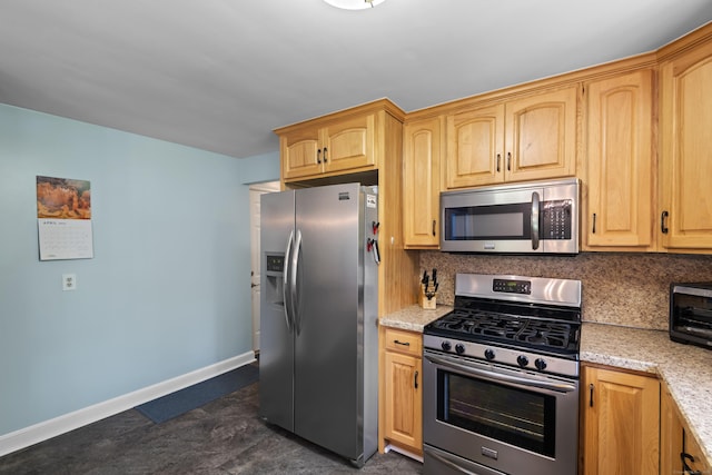 kitchen with appliances with stainless steel finishes, baseboards, tasteful backsplash, and light stone countertops