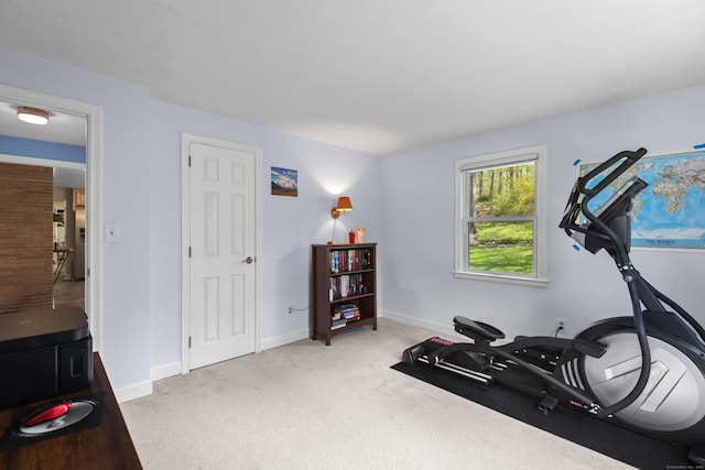 workout area with light colored carpet and baseboards