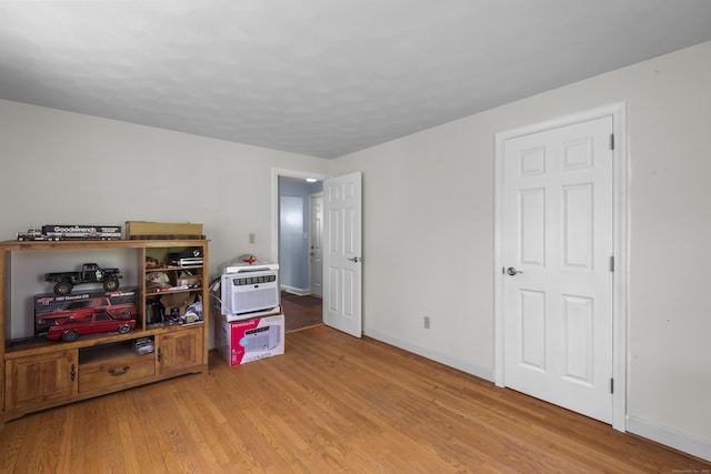 recreation room featuring light wood-type flooring and baseboards