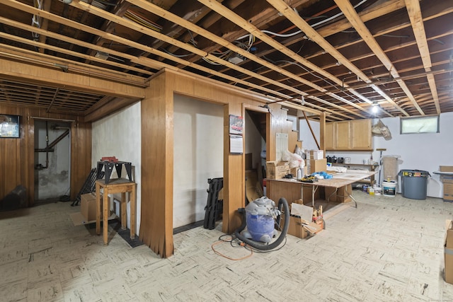 basement featuring wooden walls