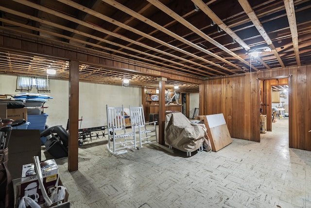 finished below grade area featuring wood walls