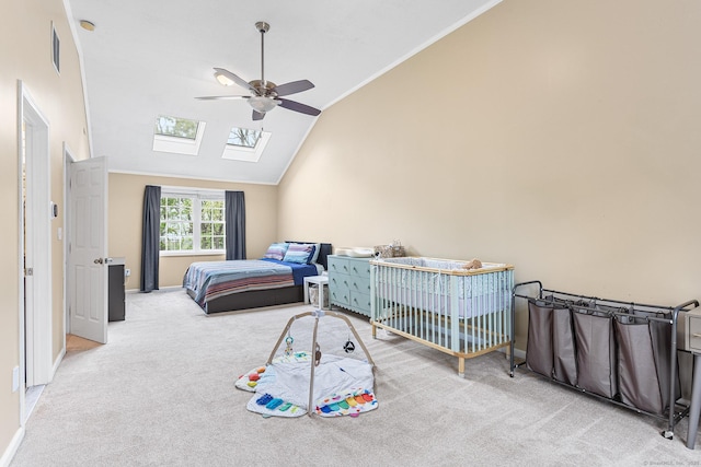 bedroom featuring a skylight, lofted ceiling, carpet flooring, ceiling fan, and baseboards