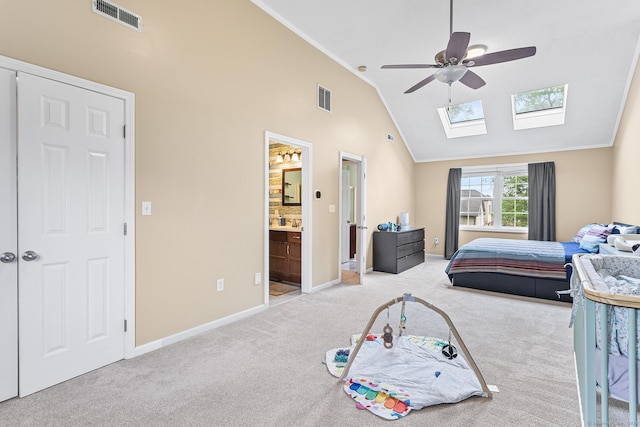 carpeted bedroom with a skylight, crown molding, baseboards, high vaulted ceiling, and ceiling fan