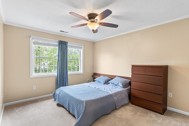bedroom featuring light colored carpet, ornamental molding, baseboards, a textured ceiling, and ceiling fan