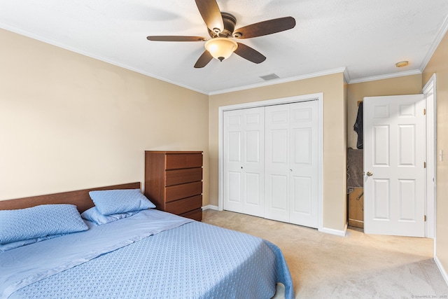 bedroom featuring a closet, light colored carpet, baseboards, crown molding, and a ceiling fan