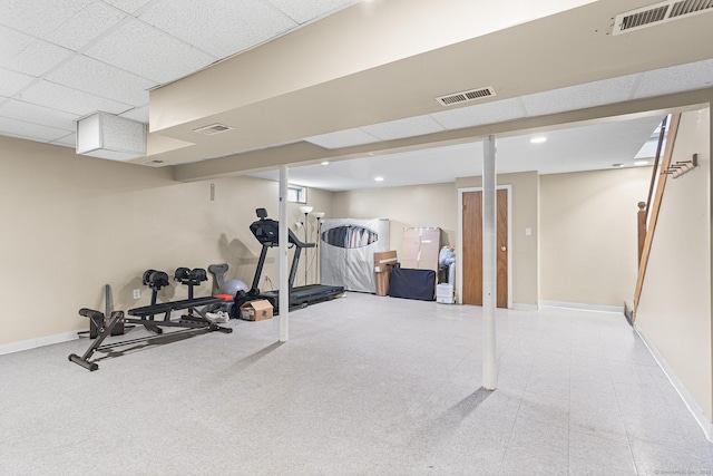 workout area with baseboards, a paneled ceiling, and recessed lighting