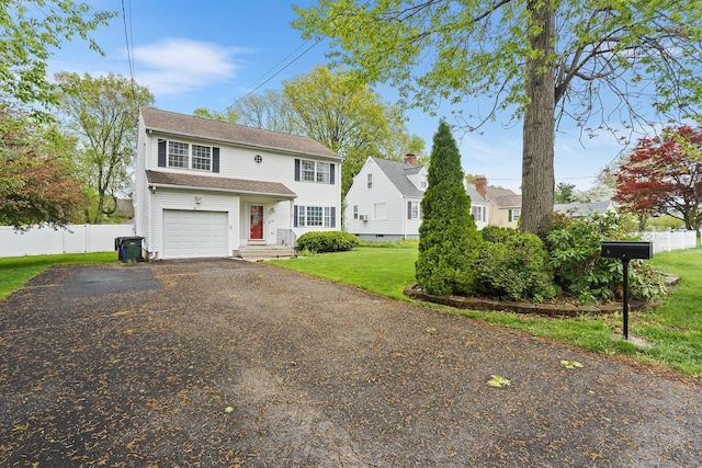 view of front of house featuring asphalt driveway and a garage