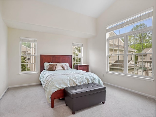 bedroom featuring baseboards, carpet flooring, and lofted ceiling