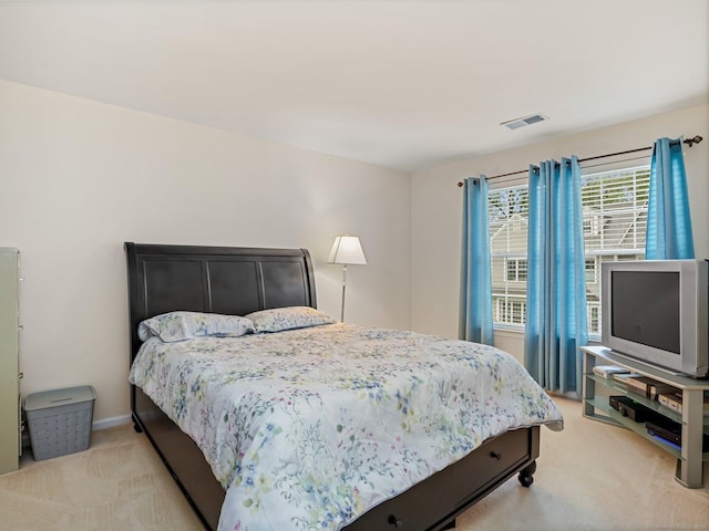 bedroom featuring light colored carpet and baseboards