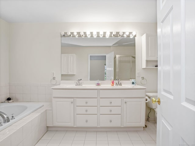 bathroom featuring a shower stall, double vanity, a bath, and tile patterned floors