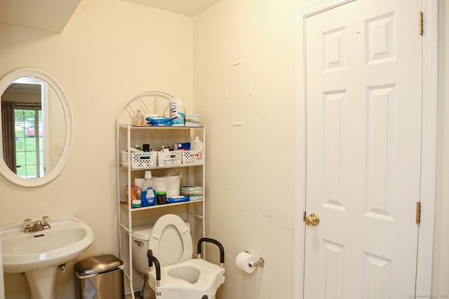 half bath with toilet and a sink