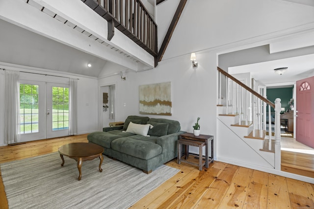 37 Hungry Hill Cir, Guilford, CT 06437 - living room featuring light wood finished floors, french doors, stairs, high vaulted ceiling, and baseboards