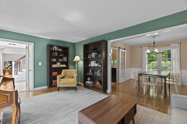 37 Hungry Hill Cir, Guilford, CT 06437 - living area featuring wood finished floors, stairs, wainscoting, and a chandelier