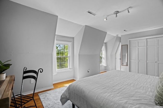 37 Hungry Hill Cir, Guilford, CT 06437 - bedroom featuring baseboards, wood finished floors, a closet, and vaulted ceiling