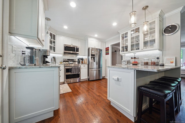 14 Live Oak Rd, Norwalk, CT 06851 - kitchen featuring stainless steel appliances, a peninsula, ornamental molding, decorative backsplash, and white cabinetry