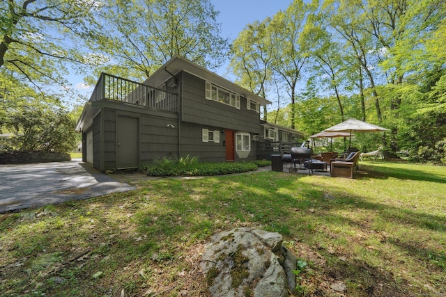 14 Live Oak Rd, Norwalk, CT 06851 - back of house with a balcony and a lawn