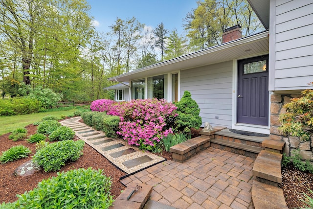 entrance to property featuring a chimney