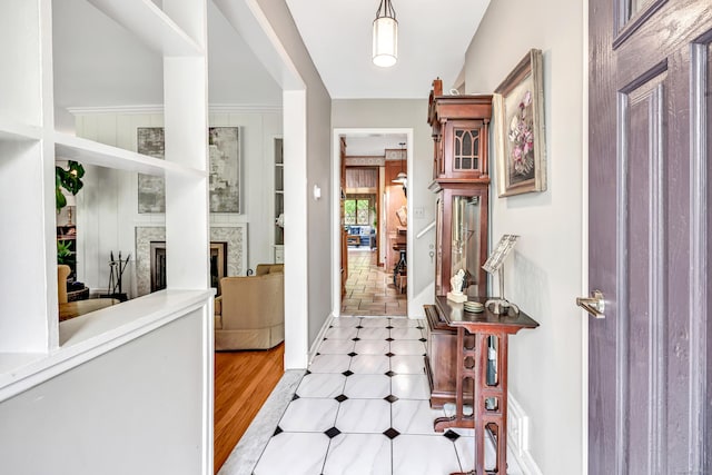 foyer featuring a tile fireplace and baseboards