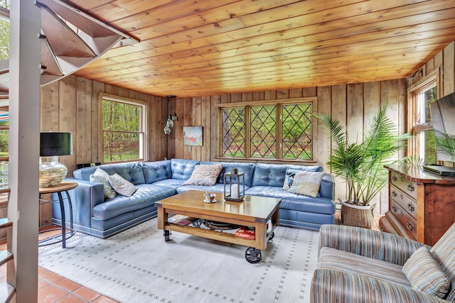 tiled living area featuring wooden ceiling and wooden walls