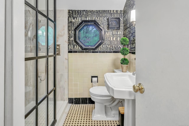 bathroom featuring tile walls, toilet, and a shower stall