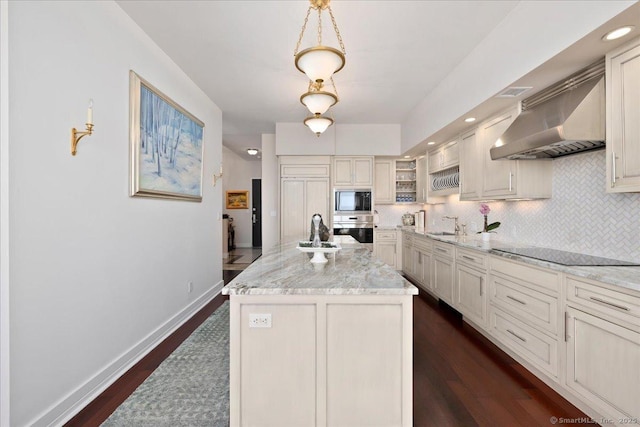 kitchen featuring ventilation hood, black appliances, decorative backsplash, a sink, and recessed lighting