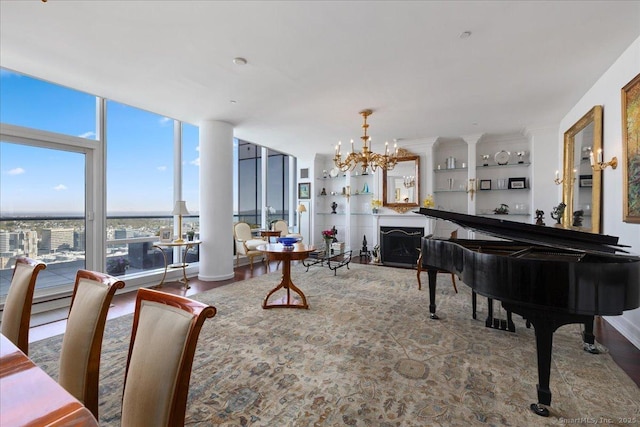 dining room with a chandelier, wood finished floors, and floor to ceiling windows