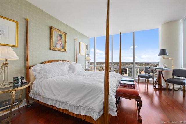 bedroom featuring wallpapered walls, expansive windows, wood-type flooring, and baseboards