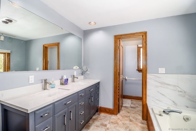 full bathroom with a sink, double vanity, baseboards, and a tub