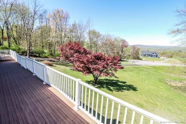 wooden terrace featuring a yard