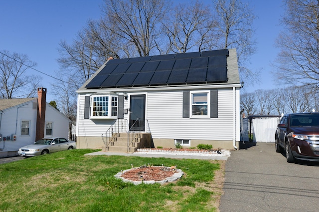 61 Kenyon Cir, New Britain, CT 06053 - bungalow-style house with entry steps, a front lawn, a standing seam roof, and solar panels