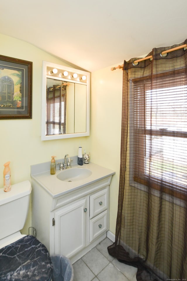 61 Kenyon Cir, New Britain, CT 06053 - bathroom with lofted ceiling, tile patterned floors, vanity, and toilet