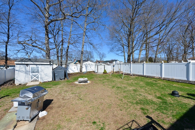 61 Kenyon Cir, New Britain, CT 06053 - view of yard with a storage shed, an outdoor structure, a fire pit, and a fenced backyard