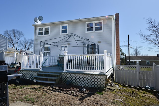 61 Kenyon Cir, New Britain, CT 06053 - back of property featuring fence, a chimney, and a deck