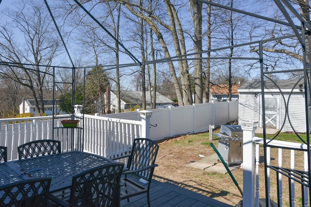 61 Kenyon Cir, New Britain, CT 06053 - wooden deck featuring outdoor dining space, a grill, a shed, an outdoor structure, and a fenced backyard