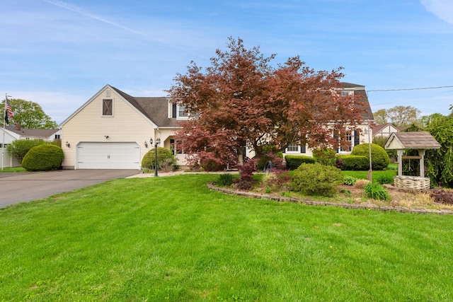 view of front of home with a front yard and concrete driveway