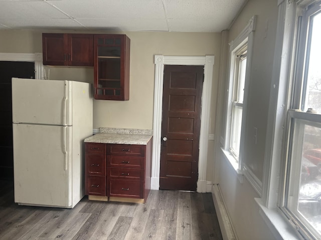 78-80 Cabot St, Hartford, CT 06154 - kitchen featuring freestanding refrigerator, reddish brown cabinets, light wood-type flooring, a paneled ceiling, and light countertops