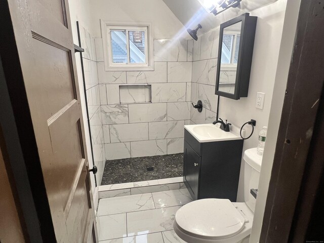 78-80 Cabot St, Hartford, CT 06154 - bathroom with marble look tile flooring, a tile shower, toilet, and vanity