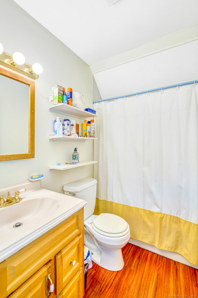 full bathroom featuring wood finished floors, toilet, vanity, lofted ceiling, and shower / bath combo
