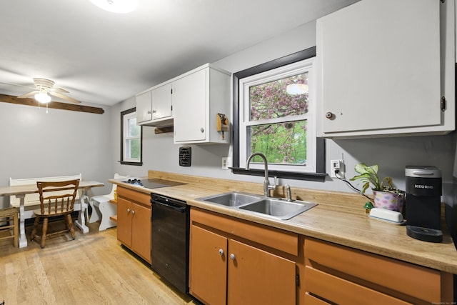 kitchen with a sink, black appliances, and light countertops