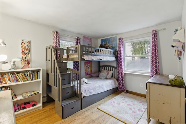 bedroom featuring wood finished floors and baseboards