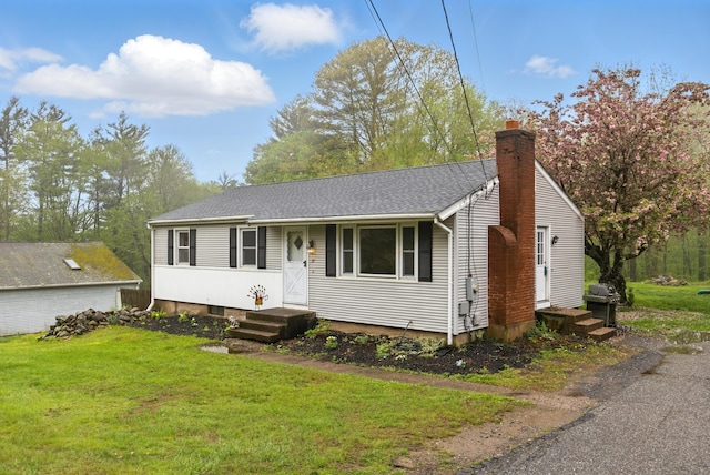 view of front of home featuring a front lawn and a chimney